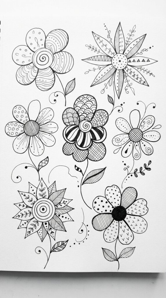 Zentangle flower doodles with patterned petals and decorative details